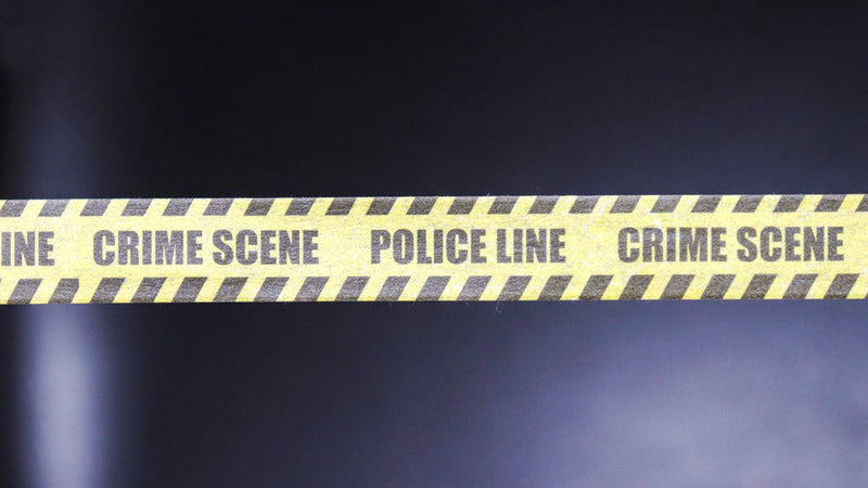 Yellow crime scene tape stretches across a dark background, marked with "POLICE LINE" and "CRIME SCENE." This image represents the investigation and speculation surrounding Candle Face and the Austin Serial Killer Rumors, highlighting the connection betwe